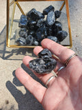 Premium Grade AA Naturally Tumbled Apache Tears from Arizona. Natural and untreated. About 1 inch wide each. Irregular oval shapes.