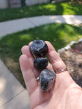 Premium Grade AA Naturally Tumbled Apache Tears from Arizona. Natural and untreated. About 1 inch wide each. Irregular oval shapes.