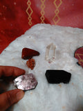 Includes: 1 Quartz Point, 1 Aragonite Cluster, 1 Red Jasper, 1 Black Tourmaline, 1 Lepidolite Slice
